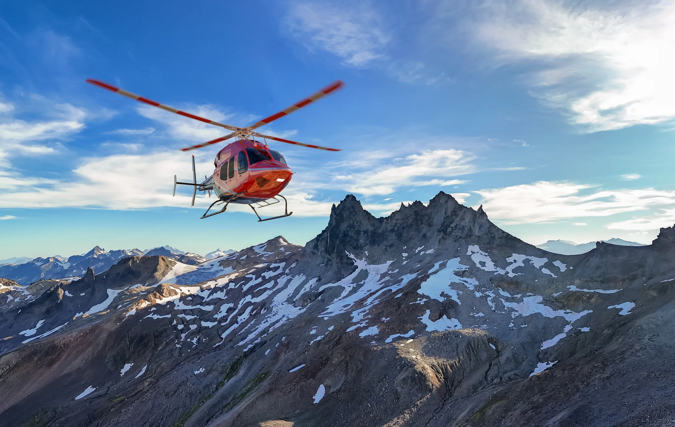 Search and rescue helicopter lifting off a snow-covered alpine basin in the Southern Alps