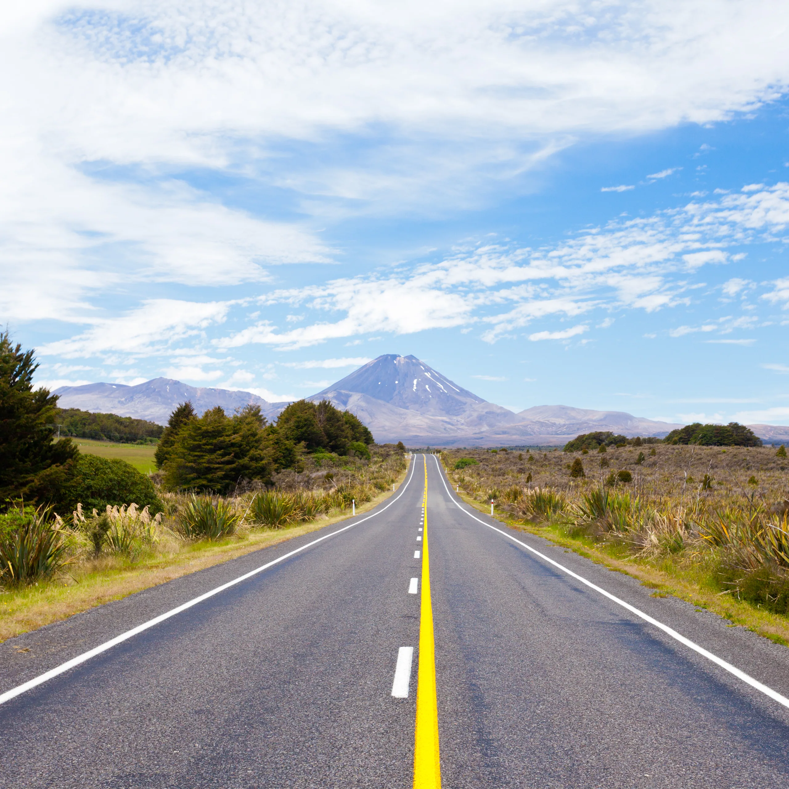 The road leading into Tongariro National Park with Mt Ngauruhoe rising at the end of the highway