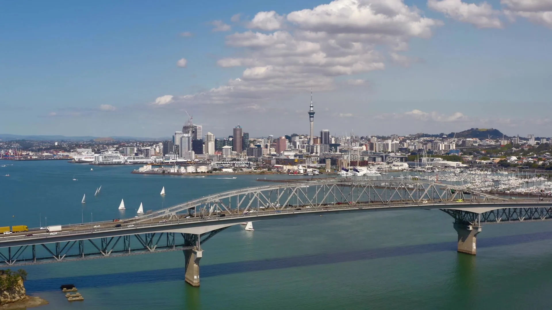 Auckland CBD and Sky Tower above the Waitemata Harbour at dusk
