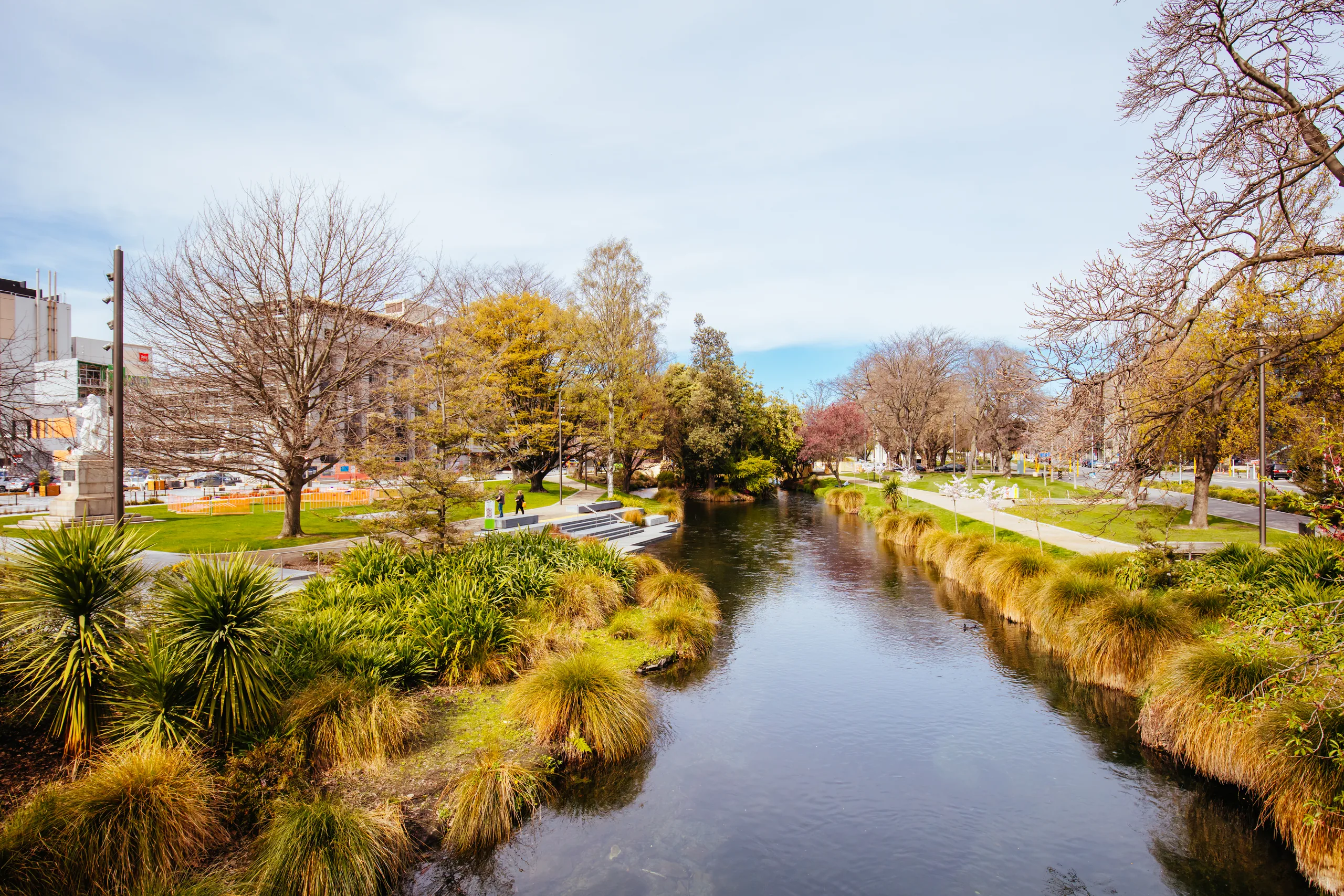The Avon River winding through central Christchurch with overhanging trees on the banks