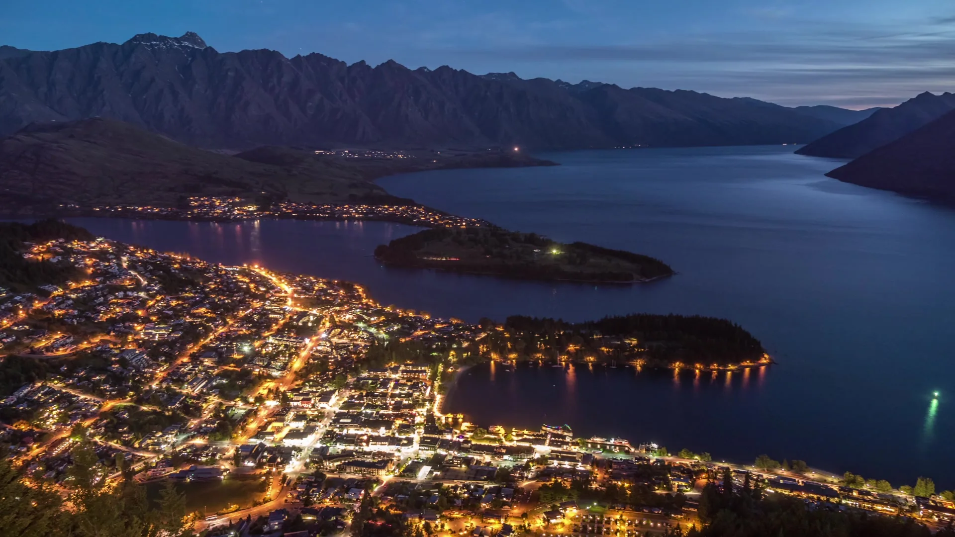Queenstown's lakefront at golden hour with the Remarkables behind