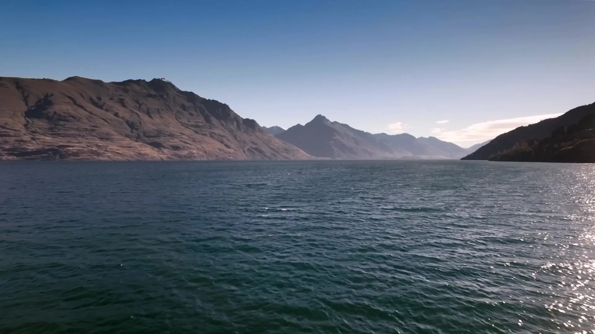 The TSS Earnslaw on Lake Wakatipu with steam rising from the funnel
