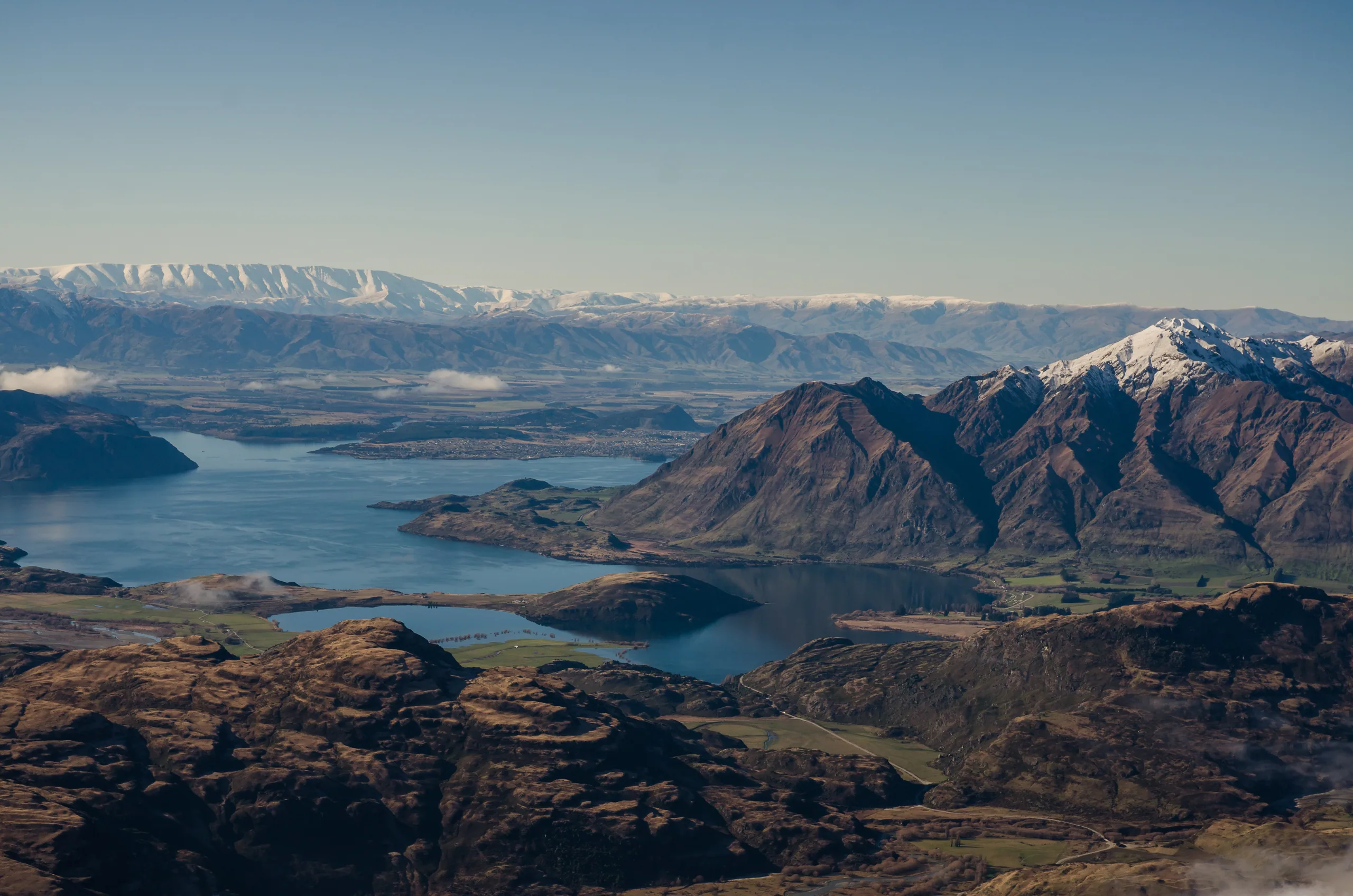 Skier on the Remarkables with Queenstown and Lake Wakatipu in the background