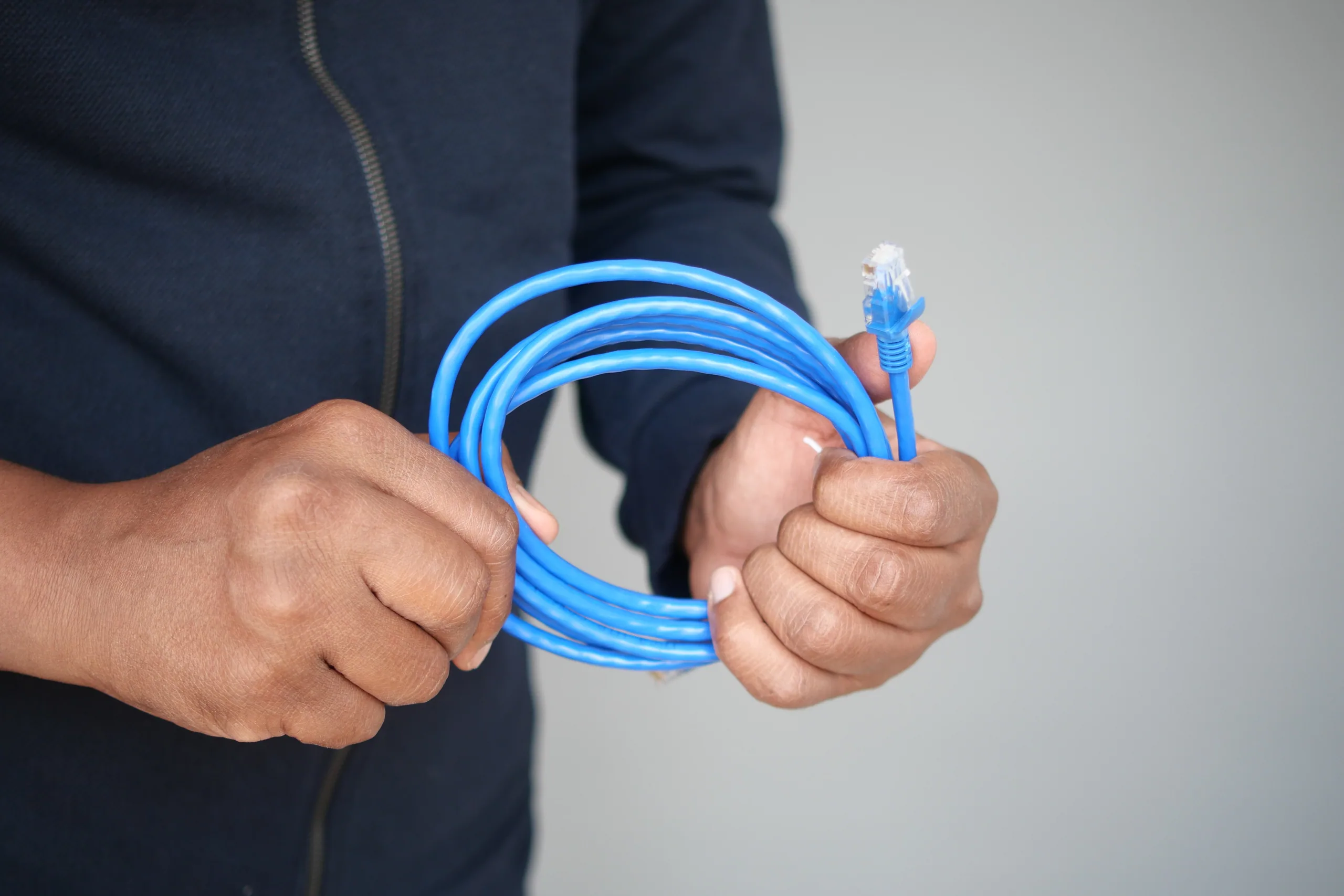 A fibre internet installer pulling cable into a New Zealand home