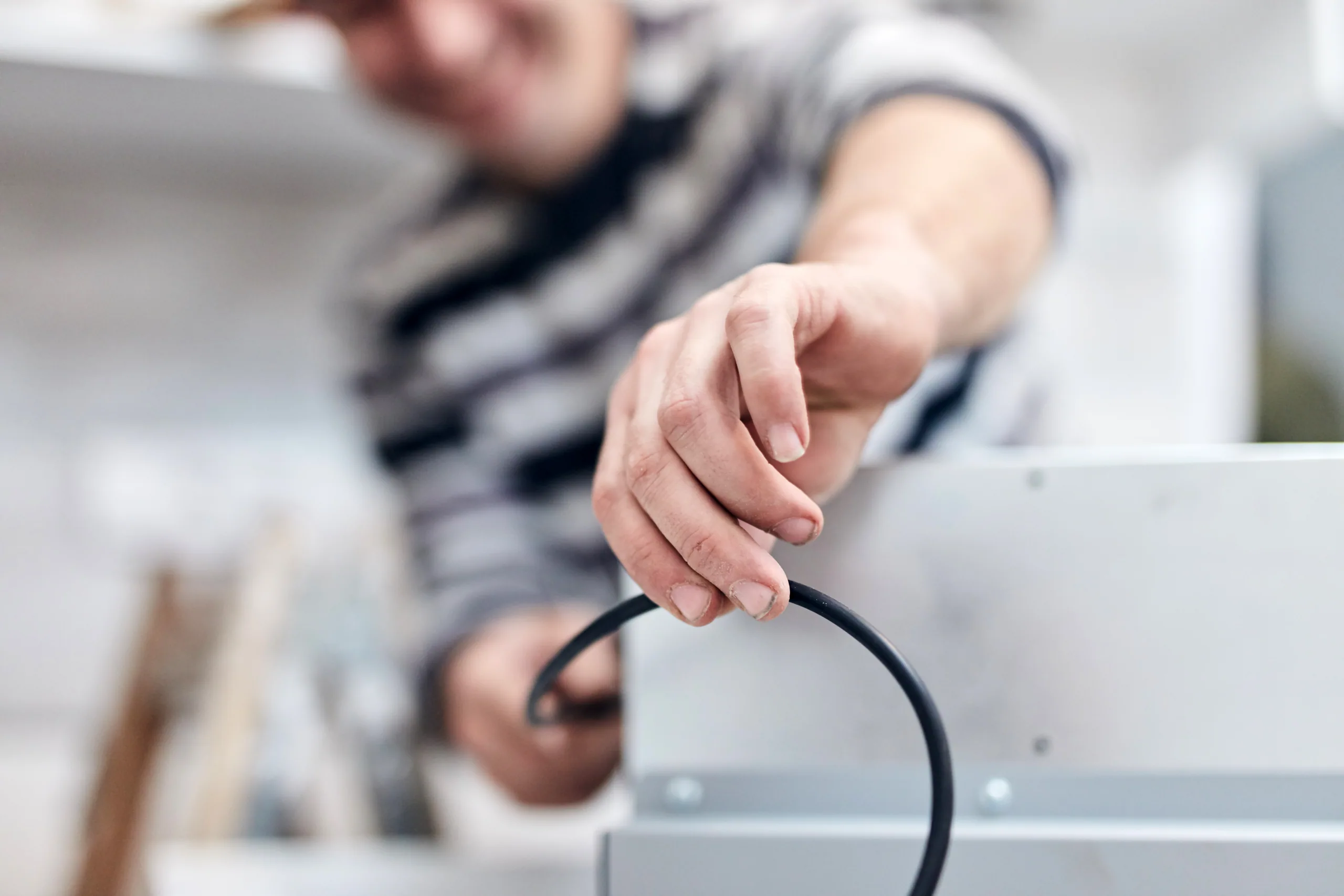 A technician working on network infrastructure cabling