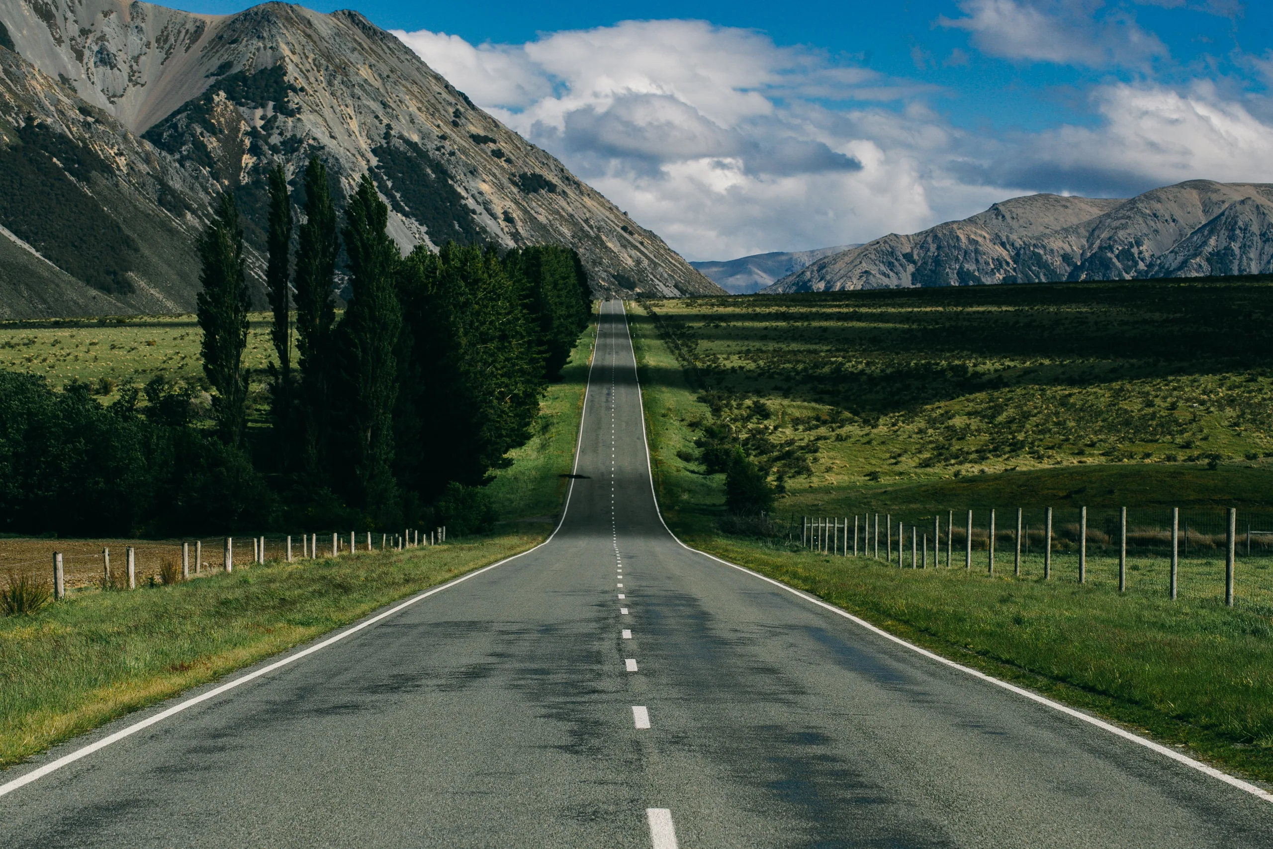 A quiet New Zealand state highway curving through open rural country