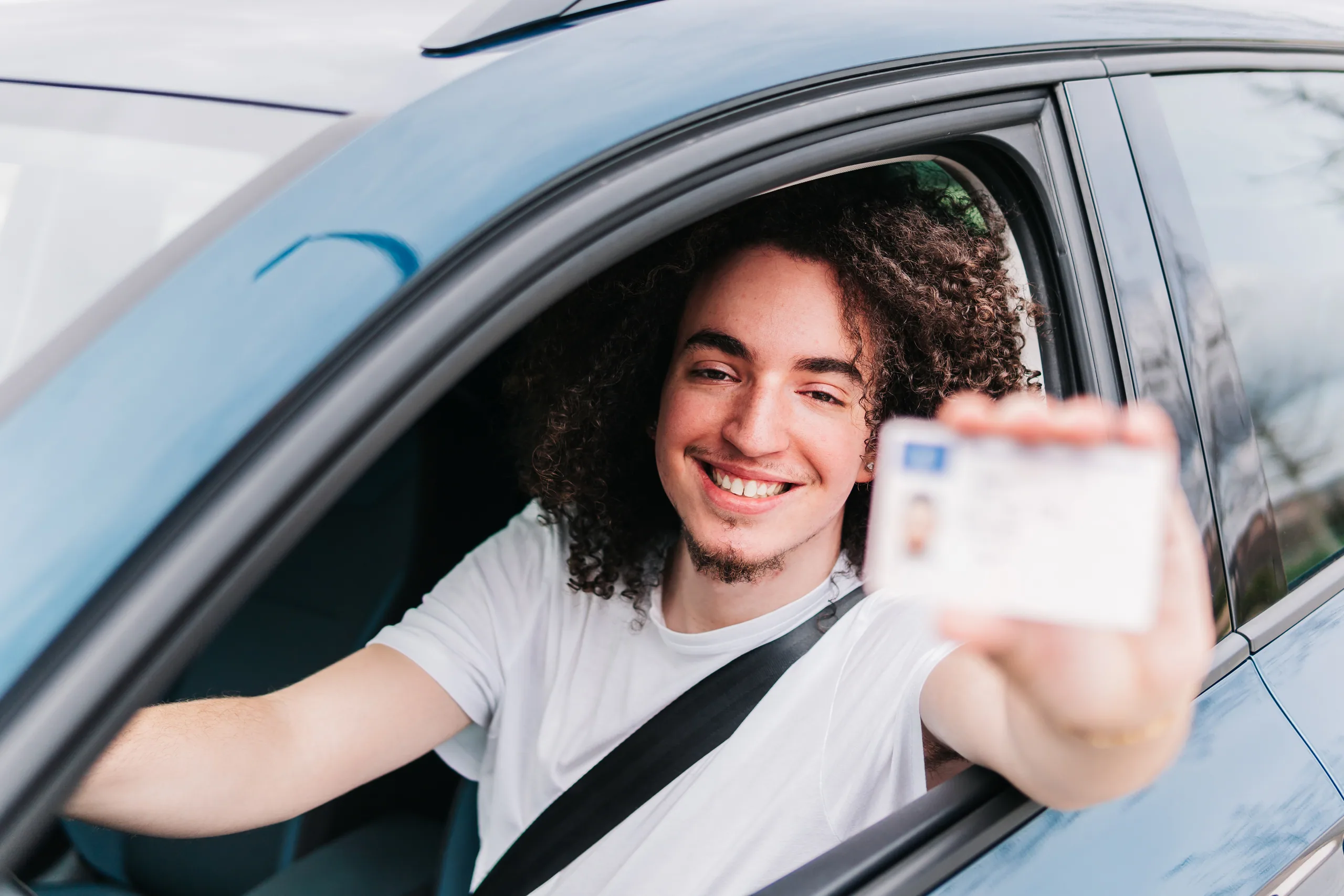 A driver licence and international driving permit on a car dashboard