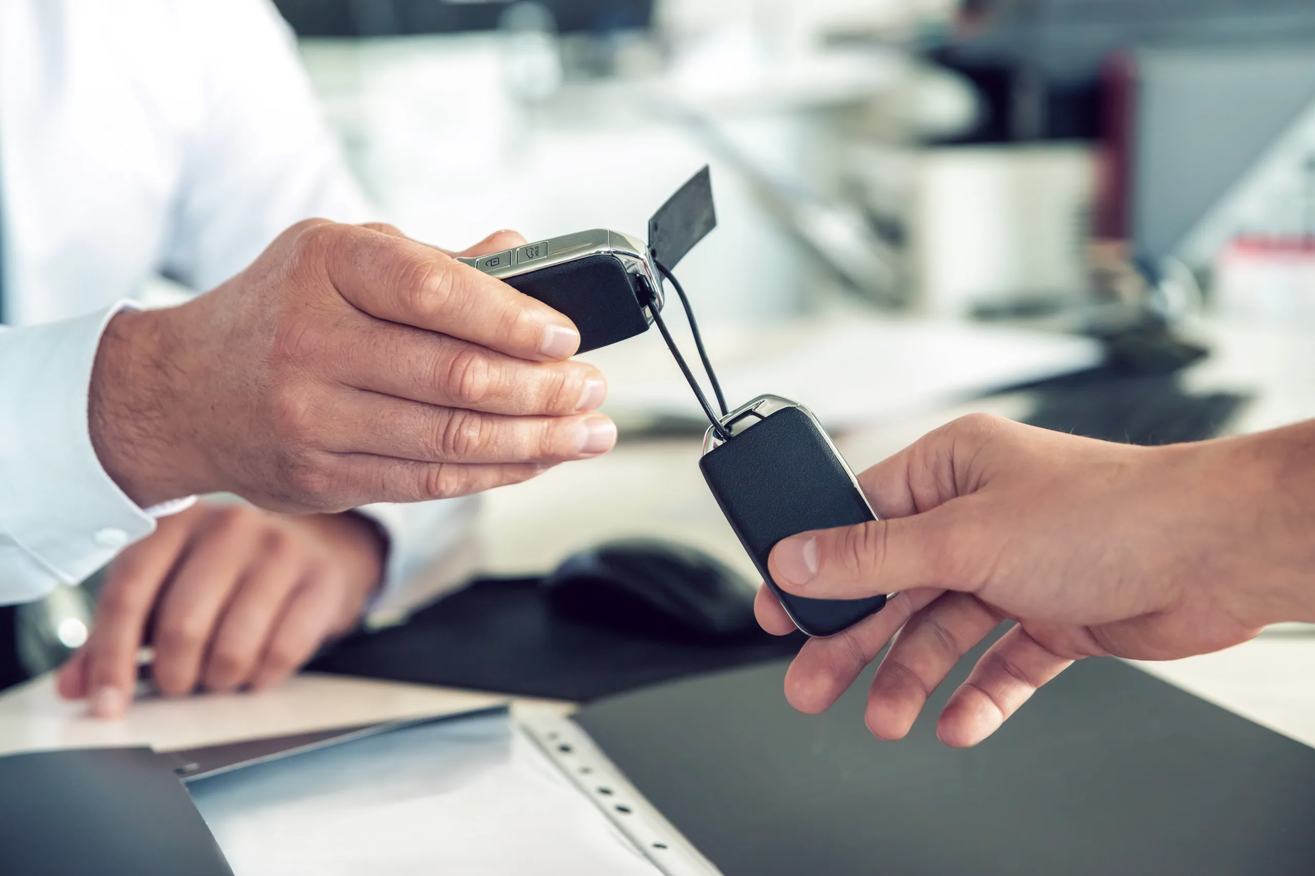 A customer signing rental car paperwork at an airport rental desk