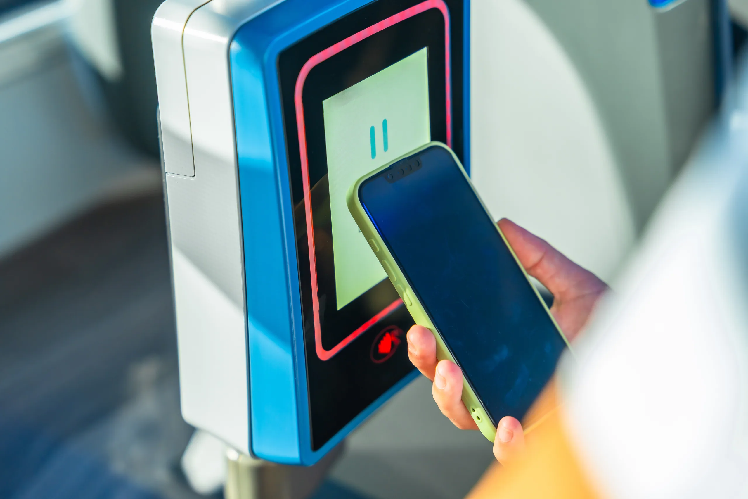 A passenger tapping a transport card on a bus reader in New Zealand