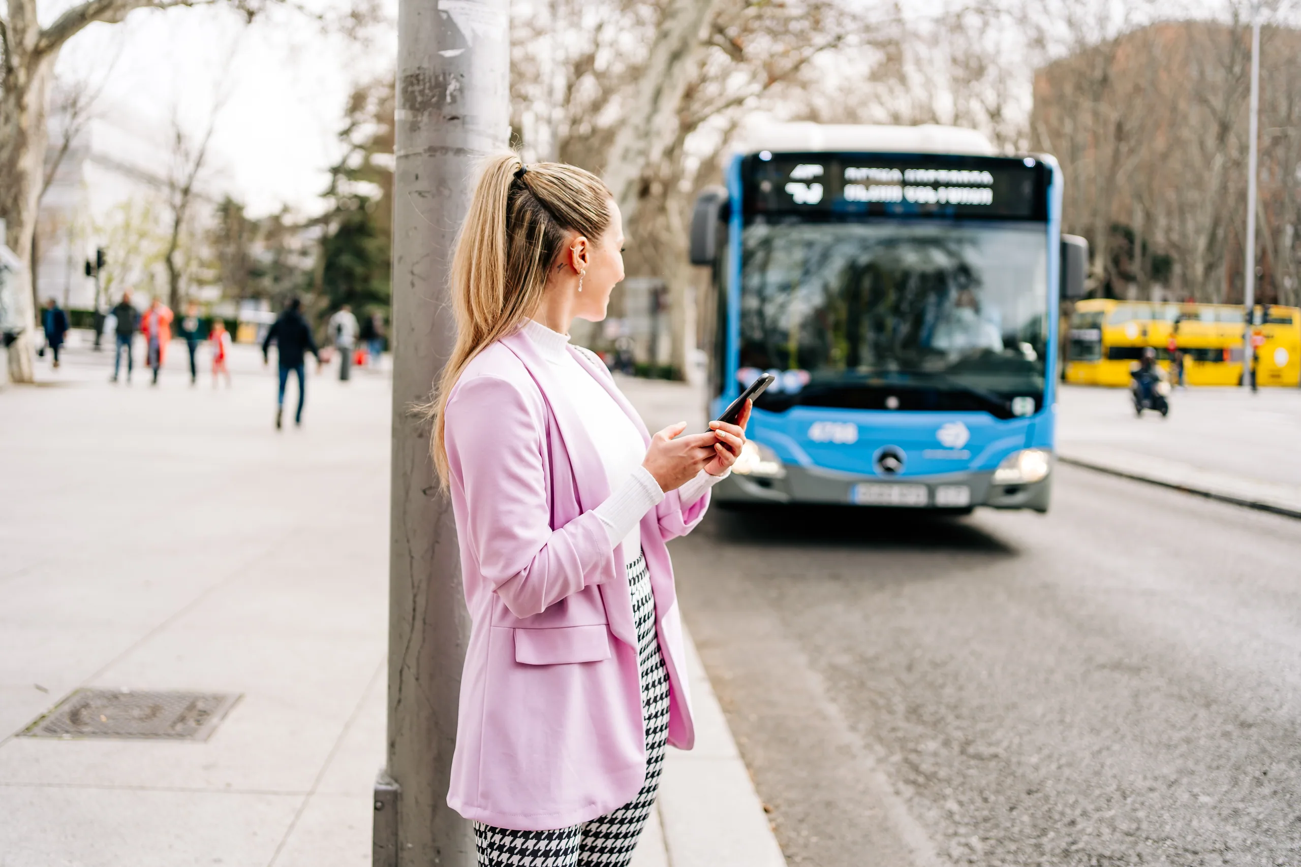 A passenger holding a transport card up to a bus card reader