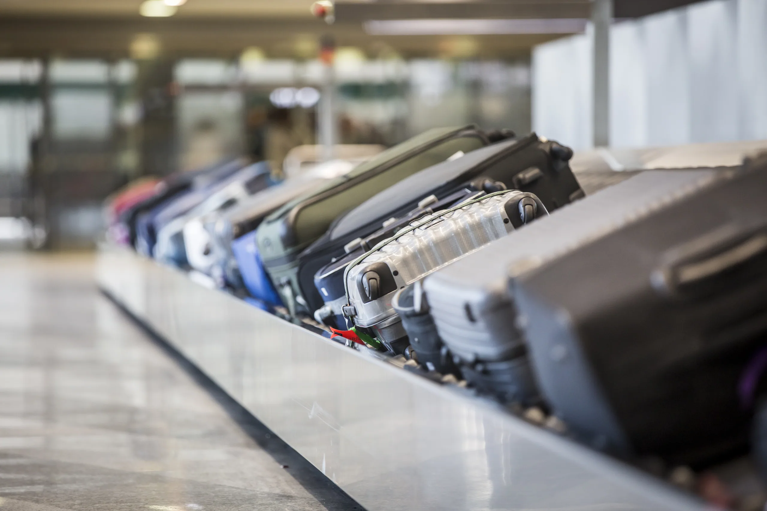 A rental car key and contract being handed over at an airport rental counter